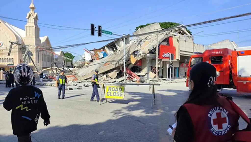 In this photo provided by the Philippine Red Cross, rescuers inspect the damage after an earthquake in General Santos, Philippines, Monday, June 8, 2026. (Philippine Red Cross via AP)