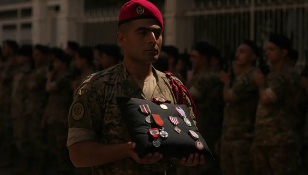 A Lebanese Army soldier carries the medals of Lebanese Brig. Gen. Wissam Sabra during his funeral procession in Beirut, Lebanon, Sunday, June 7, 2026, a day after Sabra was killed in an Israeli airstrike in south Lebanon along with a captain and another soldier, according to the Lebanese Army. (AP Photo/Hassan Ammar)