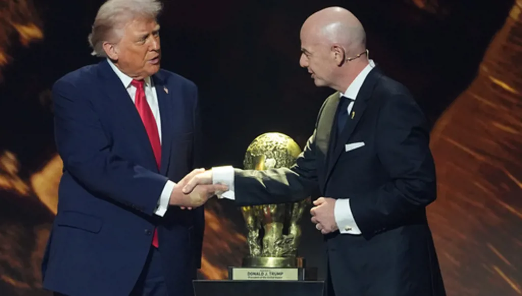 FILE - President Donald Trump shakes hands with FIFA President Gianni Infantino as he presented with the inaugural FIFA Peace Prize during the 2026 FIFA World Cup draw at the Kennedy Center, Dec. 5, 2025, in Washington. (AP Photo/Evan Vucci, File)