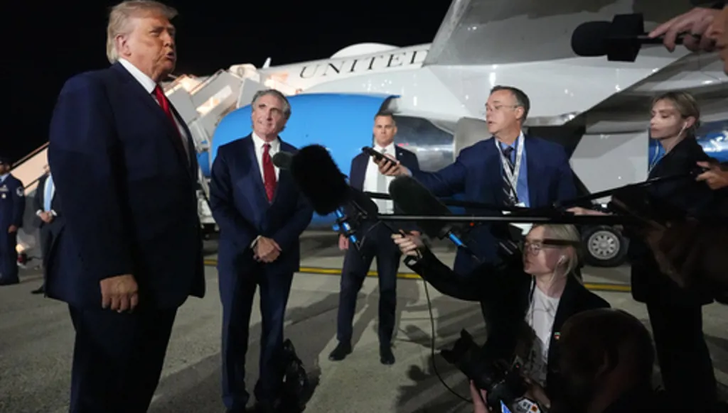 President Donald Trump talks with reporters before boarding Air Force One at John F. Kennedy International Airport in New York, early Tuesday, June 9, 2026. (AP Photo/Mark Schiefelbein)
