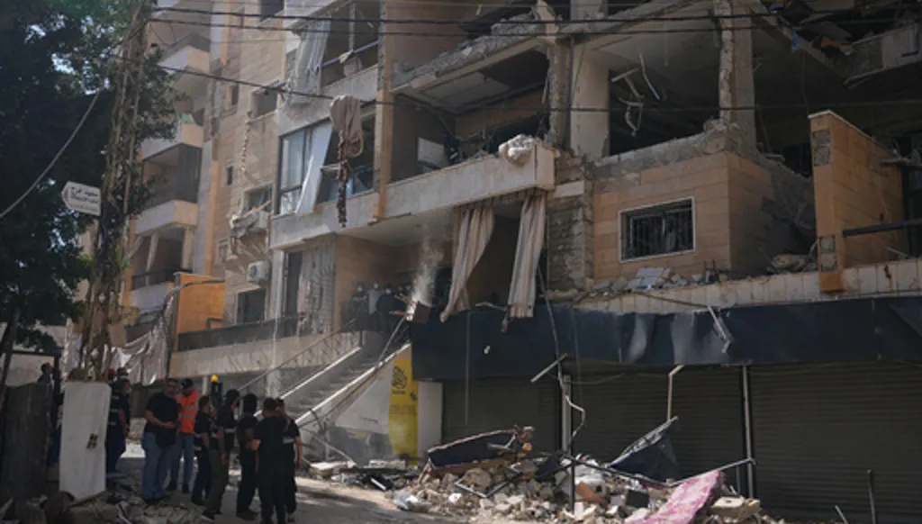Lebanese security officers gather at the site where an Israeli airstrike hit a building in Dahiyeh, Beirut's southern suburb, Lebanon, Sunday, June 7, 2026. (AP Photo/Hassan Ammar)