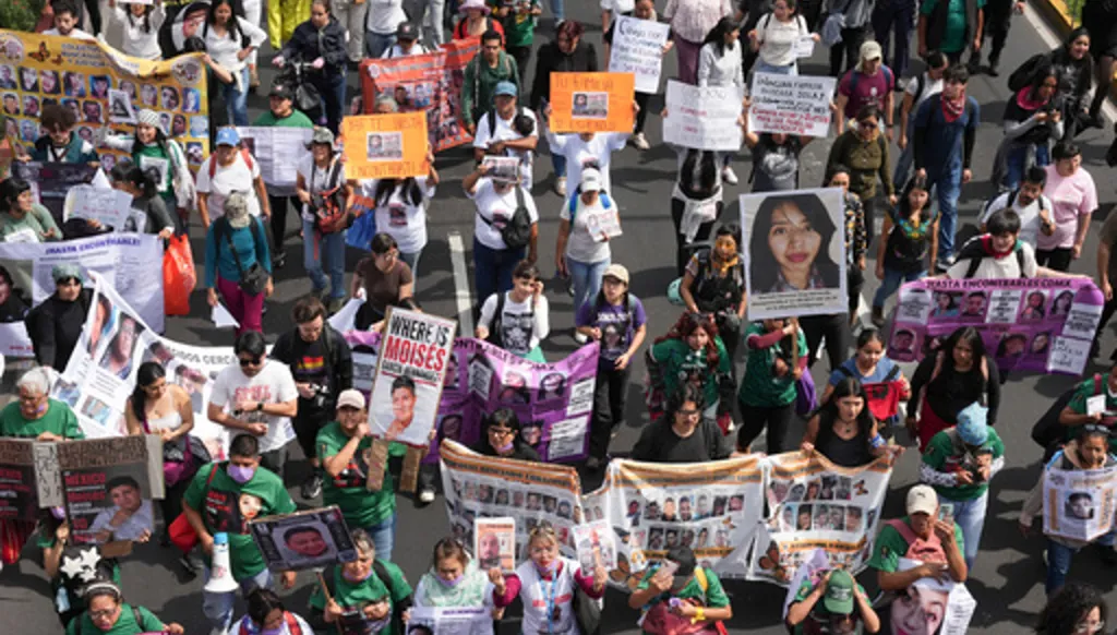 Relatives of Mexico's disappeared march before the opening match of the 2026 FIFA World Cup in Mexico City, Thursday, June 11, 2026. (AP Photo/Alejandro Cegarra)