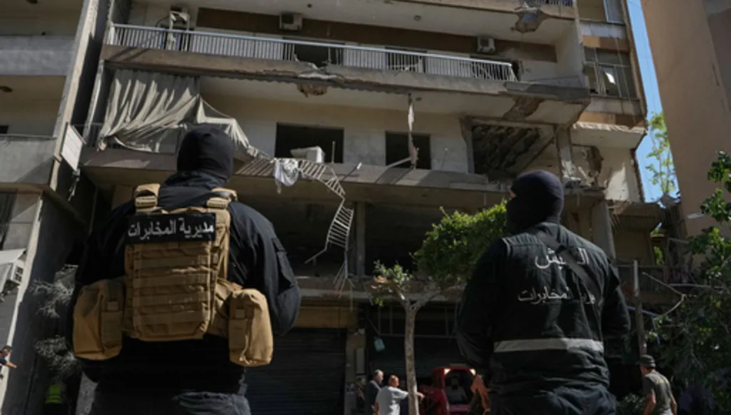 Members of the Lebanese Army Intelligence stand guard in front of an apartment that was struck in an Israeli airstrike in Dahiyeh, Beirut's southern suburbs, Lebanon, Sunday, June 14, 2026. (AP Photo/Bilal Hussein)