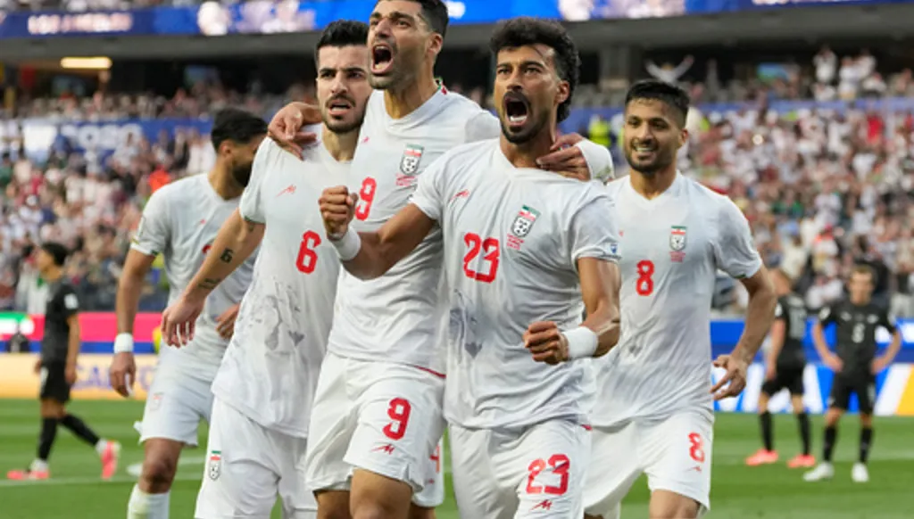 Iran's Ramin Rezaeian (23) celebrates with his teammates after scoring a goal during the World Cup Group G soccer match between Iran and New Zealand in Inglewood, Calif., near Los Angeles, Monday, June 15, 2026. (AP Photo/Andre Penner)