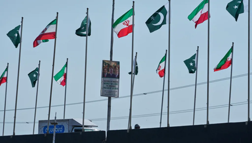 The welcoming billboard, featuring Iranian President Masoud Pezeshkian, right, with Pakistan President Asif Ali Zardari, center, and Prime Minister Shehbaz Sharif, is displayed alongside of an overhead bridge, in Islamabad, Pakistan, Tuesday, June 23, 2026. (AP Photo/Anjum Naveed)