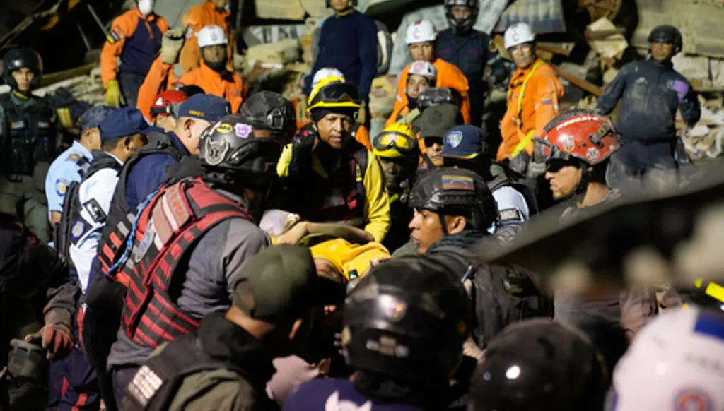 Rescue workers search through the rubble of a collapsed building after earthquake in Caracas, Venezuela, Wednesday, June 24, 2026. (AP Photo/Ariana Cubillos)