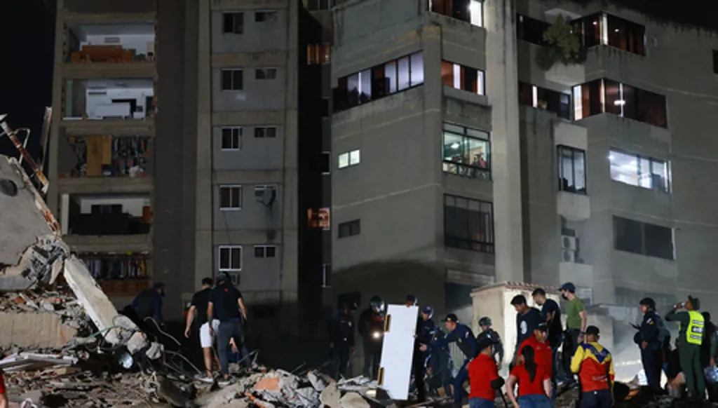 Rescue workers search through the rubble after an earthquake in Caracas, Venezuela, Wednesday, June 24, 2026.(AP Photo/Javier Campos)