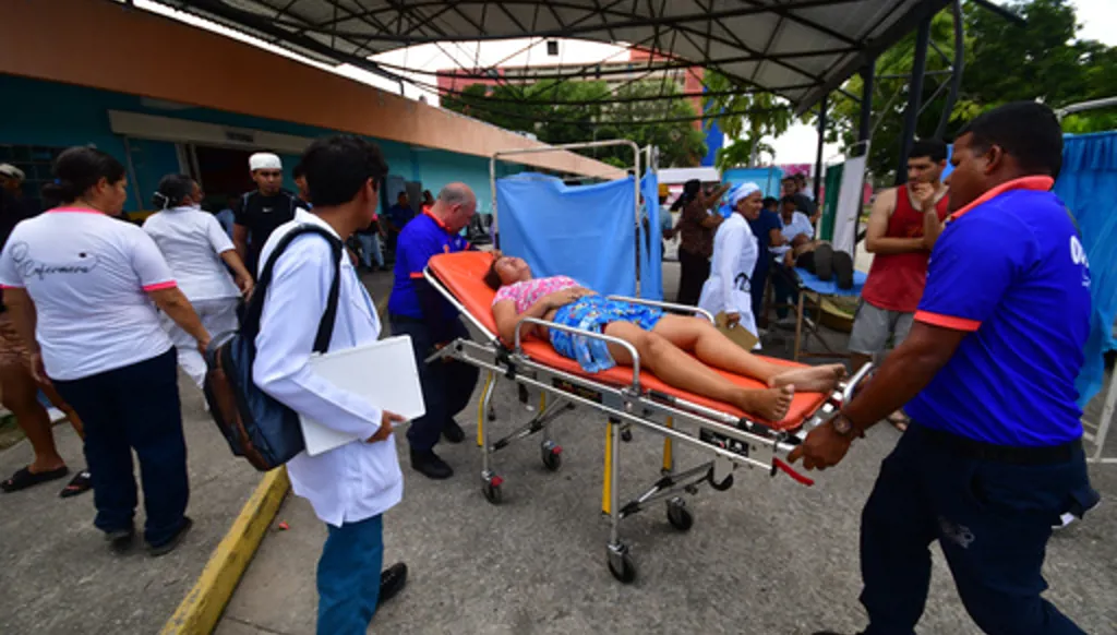 Paramedics carry an injured person at a hospital in Moron,near the epicenter of two earthquakes that struck Venezuela a day earlier, Thursday, June 25, 2026. (AP Photo/Jacinto Oliveros)