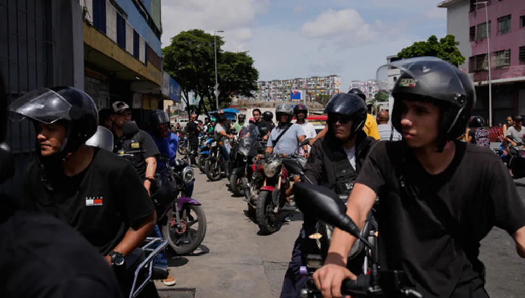 Motorcyclists wait in line to fill their tanks in Caracas, Venezuela, Thursday, June 25, 2026, a day after successive powerful earthquakes struck the country. (AP Photo/Ariana Cubillos)