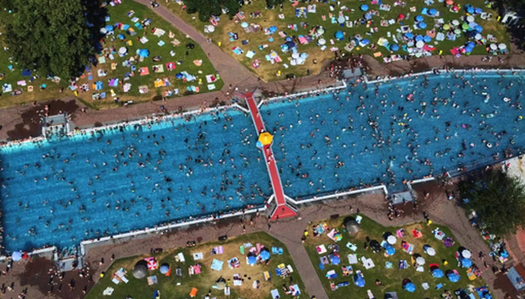 Hundreds of people gather in a public pool in Frankfurt, Germany, on a hot Saturday, June 27, 2026. (AP Photo/Michael Probst)