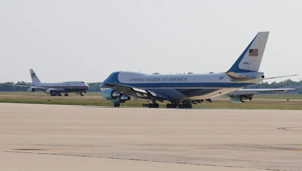 The newly designated Air Force One, left, with president Donald Trump on board, takes off on the runway as the old version of the plane is in the foreground, at Joint Base Andrews, Md., Wednesday, July 1, 2026 (AP Photo/Luis M. Alvarez)