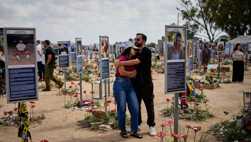 FILE - People mark Israel's annual Memorial Day at the site of the Nova music festival, where hundreds of revelers were killed and abducted in the Oct. 7, 2023 Hamas attack, near Kibbutz Reim in southern Israel, April 21, 2026. (AP Photo/Ohad Zwigenberg, File)