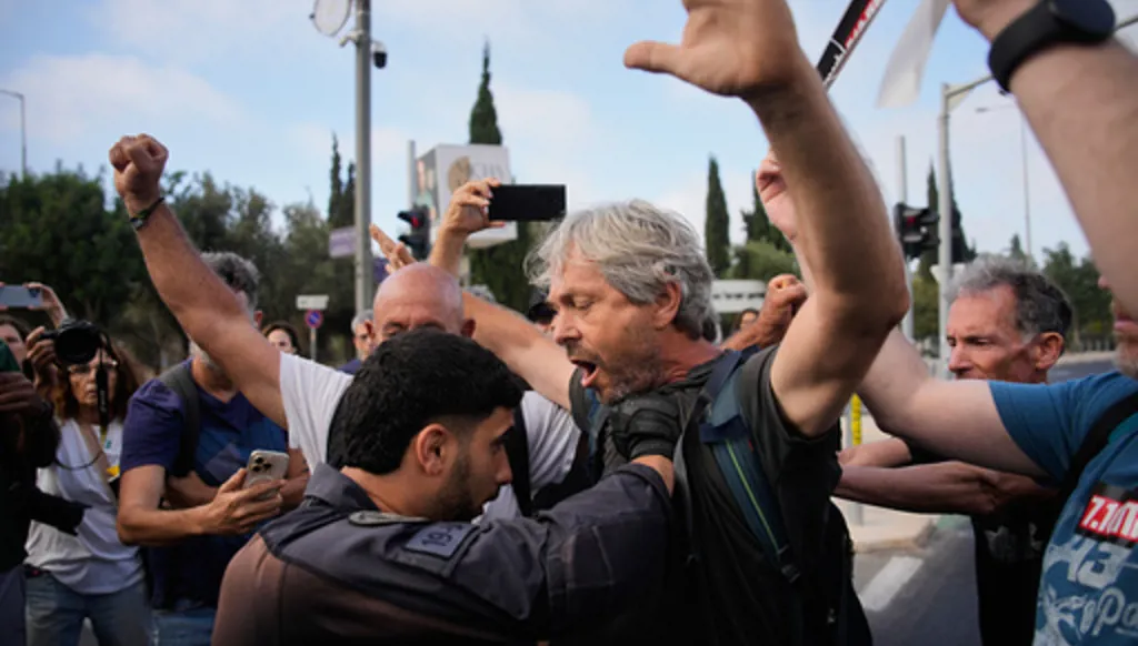 Police disperse demonstrators during a protest marking 1,000 days since the Oct. 7 2003 Hamas-led attack on Israel, outside of the Knesset, Israel's parliament, in Jerusalem, Thursday, July 2, 2026. (AP Photo/Ohad Zwigenberg)