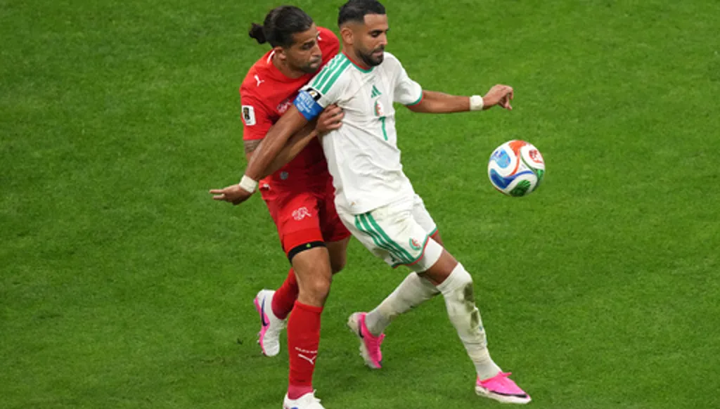 Switzerland's Ricardo Rodriguez (13) battles with Algeria's Riyad Mahrez (7) during the World Cup round of 32 soccer match between Switzerland and Algeria in Vancouver, British Columbia, Thursday, July 2, 2026. (AP Photo/Nick Didlick)