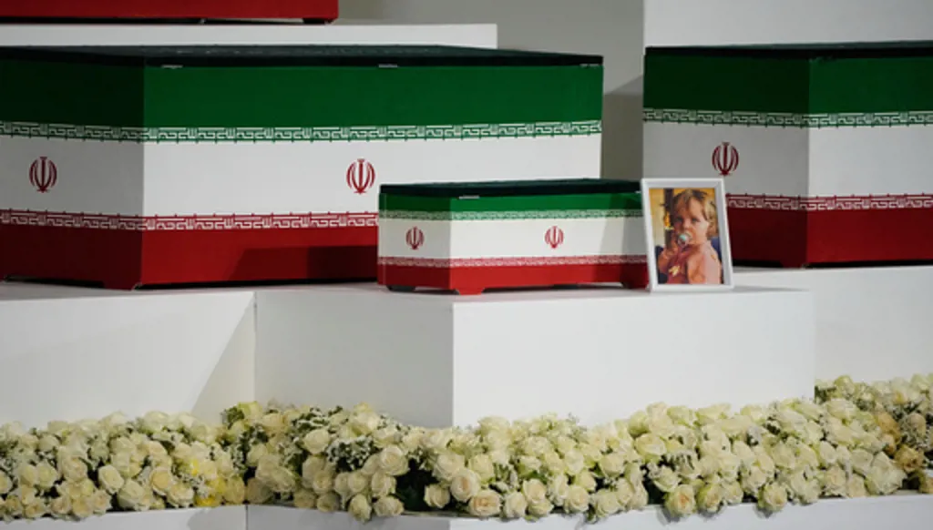 The casket of slain Iranian Supreme Leader Ayatollah Ali Khamenei's granddaughter, Zahra Mohammadi Golpayegani, is displayed alongside the caskets of Khamenei and other members of his family during a viewing ceremony ahead of the dayslong funeral ceremonies at the Imam Khomeini Mosalla Grand Mosque in Tehran, Iran, Friday, July 3, 2026. (AP Photo/Vahid Salemi)