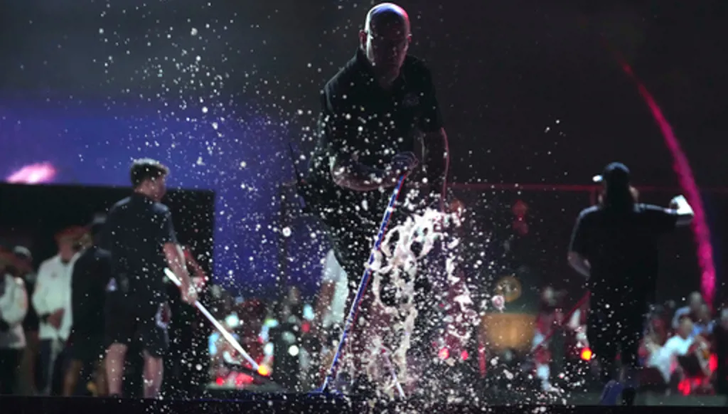 Workers clear water from the stage before President Donald Trump speaks at an Independence Day event honoring the nation's 250th anniversary, Saturday, July 4, 2026, on the National Mall in Washington. (AP Photo/Mark Schiefelbein)