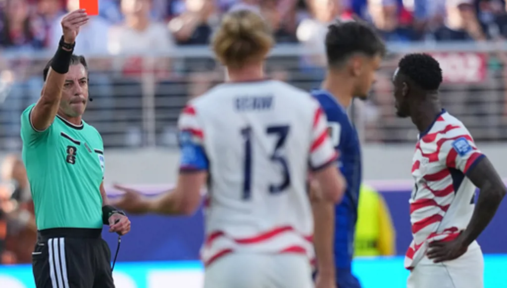 Referee Raphael Claus of Brazil shows a red card to United States' Folarin Balogun, right, during the World Cup round of 32 soccer match between the United States and Bosnia in Santa Clara, Calif., near San Francisco, Wednesday, July 1, 2026. (AP Photo/Julio Cortez)