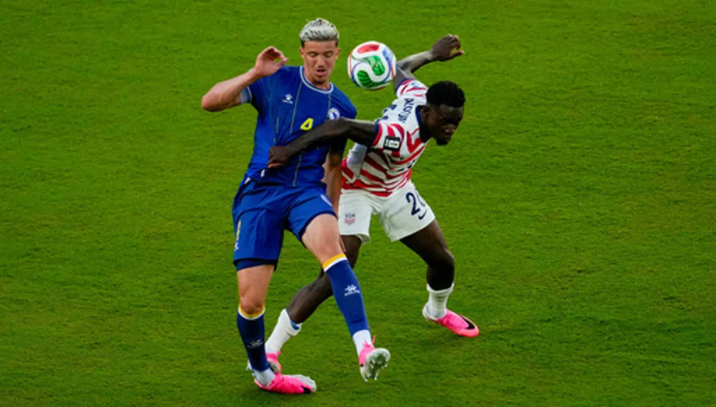 United States' Folarin Balogun (20) fouls Bosnia's Tarik Muharemovic (4) during the World Cup round of 32 soccer match between the United States and Bosnia in Santa Clara, Calif., near San Francisco, Wednesday, July 1, 2026. Balogun received a red card on the play. (AP Photo/Jeff Chiu)