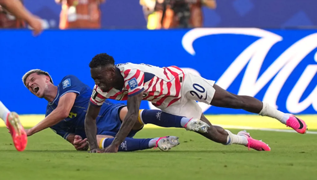 Bosnia's Tarik Muharemovic (4) reacts after a tackle form United States' Folarin Balogun (20) during the World Cup round of 32 soccer match between the United States and Bosnia in Santa Clara, Calif., near San Francisco, Wednesday, July 1, 2026. (AP Photo/Julio Cortez)