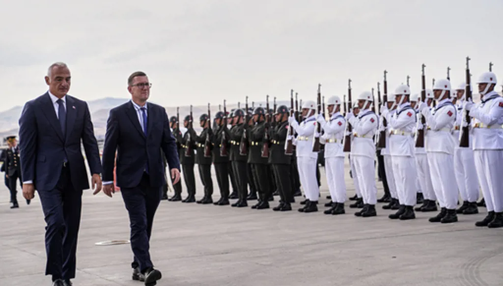 Estonia's Prime Minister Kristen Michal, center left, walks with Turkish Culture and Tourism Minister Mehmet Nuri Ersoy, left, during airport arrivals ahead of the NATO Summit in Ankara, Turkey, Monday, July 6, 2026. (Metin Aktas, Pool Photo via AP)