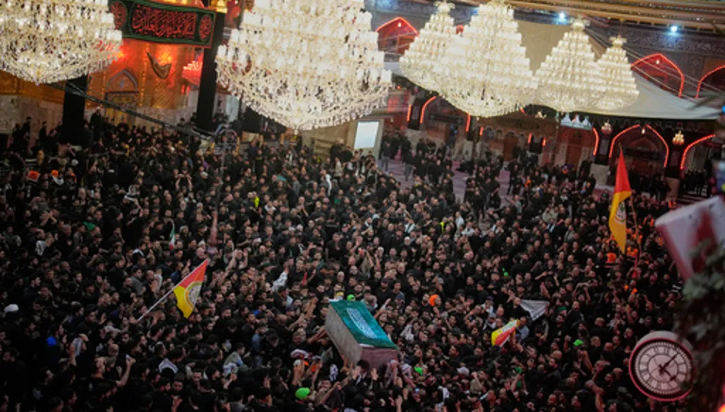 The coffin of the late Iranian Supreme Leader Ayatollah Ali Khamenei is carried through a crowd of mourners at the Imam Hussein Shrine in Karbala, Iraq, early Thursday, July 9, 2026. (AP Photo/Khalil Hamra)