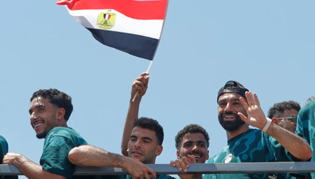 Mohamed Salah, right, smiles as he is greeted by fans upon the Egyptian national soccer team arrival at El-Alamein airport, 160 km (99 miles) west of Alexandria, Egypt, Friday, July 10, 2026. (AP Photo)
