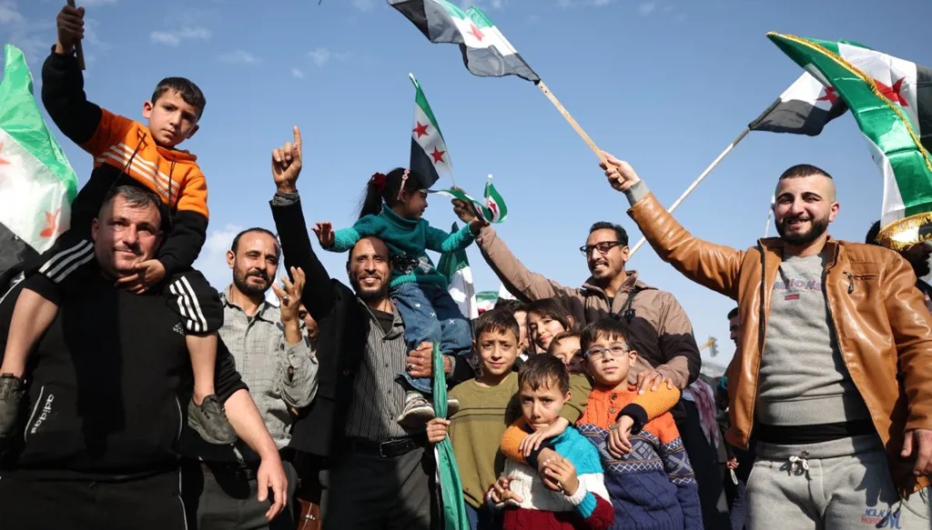 سوريون يحتفلون بذكرى سقوط الأسد (أ ف ب).