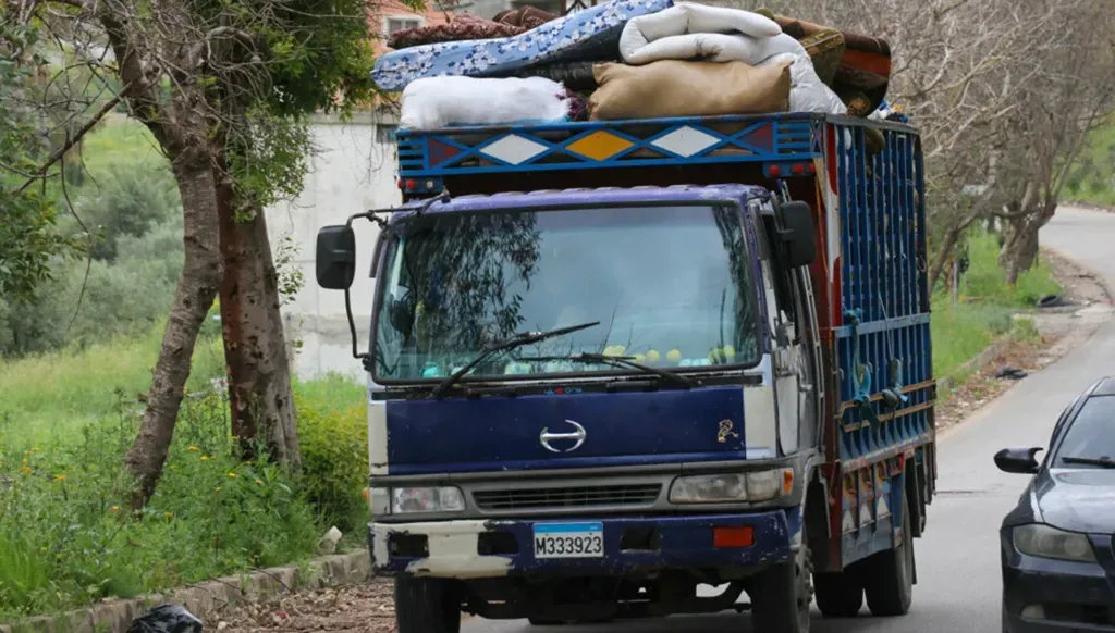A truck carrying displaced people. (AFP)