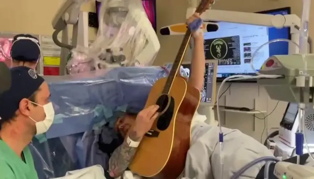 أب يعزف الغيتار أثناء جراحة دماغية لإزالة ورم نادر (فيديو)