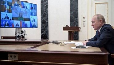 بوتين مترئسا اجتماعا للحكومة عبر الفيديو في الكرملين في موسكو (12 ك2 2022، أ ف ب). 