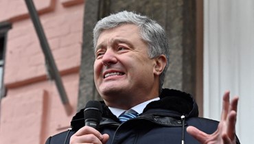 بوروشنكو مخاطبا مؤيديه خلال استراحة لجلسة محاكمة في كييف (17 ك2 2022، أ ف ب). 
