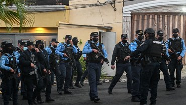  عناصر من الشرطة انتشروا خارج منزل هرنانديز في تيغوسيغالبا (15 شباط 2022، ا ف ب). 
