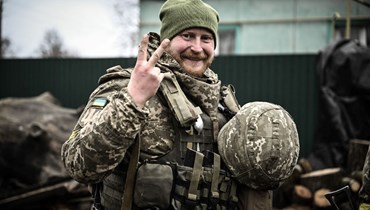 جندي أوكراني يرفع علامة النصر على خط المواجهة شمال شرق كييف (3 آذار 2022، أ ف ب). 