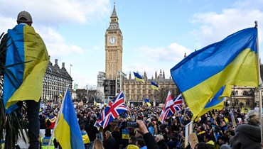 متظاهرون يحملون لافتات وأعلاما أوكرانية وبريطانية خلال مسيرة في وسط لندن احتجاجا على الغزو الروسي لأوكرانيا (6 آذار 2022، أ ف ب). 