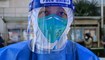 عامل صحي يستعدّ لإجراء اختبار مسحة لفيروس كورونا في شنغهاي (4 نيسان 2022 - أ ف ب).