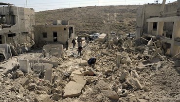 صورة ارشيفية- اشخاص يتفقدون الأضرار بعد غارة جوية إسرائيلية بالقرب من دمشق (7 آذار 2022، أ ب). 