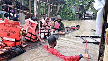 إجلاء سكان في بلدة بانيتان في مقاطعة كابيز، اثر فيضانات خلفتها العاصفة الاستوائية ميجي (12 نيسان 2022، أ ف ب). 