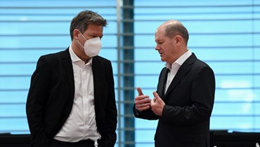 شولتس (الى اليمين) يتحدث الى وزير الاقتصاد الألماني روبرت هابك خلال جلسة لمجلس الوزراء الأمني الألماني في مقر المستشارية في برلين (12 نيسان 2022، ا ف ب). 