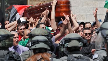 مواجهات بين قوات الأمن الإسرائيلية ومشيعين فلسطينيين خلال حمل نعش ابو عاقلة خارج المستشفى (13 ايار 2022، أ ف ب).