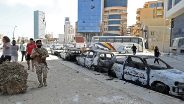 سيارات محترقة في طرابلس من جراء الاشتباكات (17 ايار 2022، أ ف ب). 