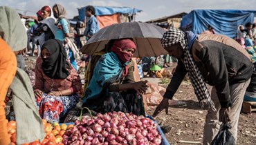 امرأة تبيع الخضار في بيكوجي بإثيوبيا (14 ايار 2022، أ ف ب).