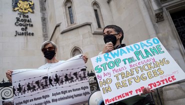 متظاهرون تجمعوا أمام المحكمة العليا في لندن احتجاجاً على خطة لجوء بريطانيا الى رواندا (13 حزيران 2022، أ ف ب). 