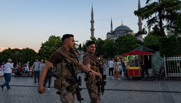 عنصران من الشرطة التركية يمشيان قرب المسجد الأزرق في اسطنبول (14 حزيران 2022، أ ف ب). 