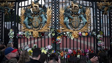 بريطانيون يقفون أمام قصر بكنغهام في لندن حداداً على الملكة إليزابيث (أ ف ب).
