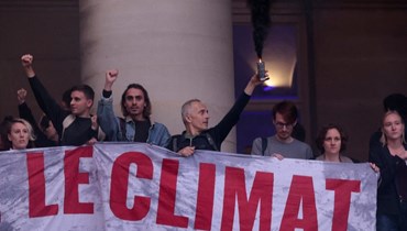 نشطاء من مجموعتي "أصدقاء الارض" و"الترناتيبا" يشاركون في تحرك ضد فعالية يوم تمويل المناخ في باريس (27 ت1 2022، أ ف ب). 