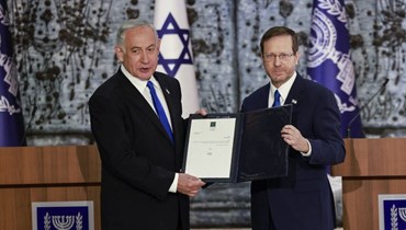 الرئيس الإسرائيلي إسحاق هرتسوغ ورئيس حزب الليكود بنيامين نتنياهو بعد أن كُلّف الأخير تشكيل حكومة جديدة (13 ت2 2022 - أ ف ب).