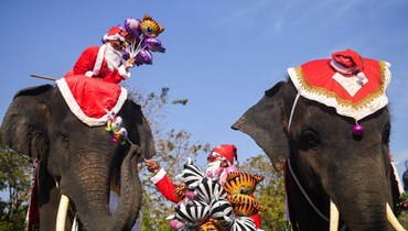 "بابا نويل" يوزّع الهدايا من فوق ظهور الأفيال في تايلاند.