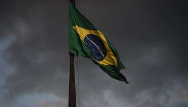   علم برازيلي يرفرف خارج مبنى المحكمة العليا في برازيليا (أ ف ب).
