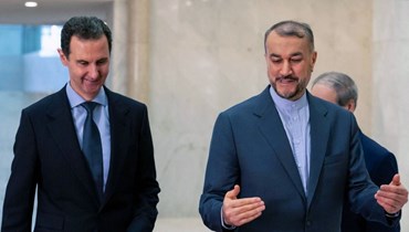 الأسد (إلى اليسار) يستقبل عبداللهيان في دمشق (14 ك2 2023، أ ف ب). 
