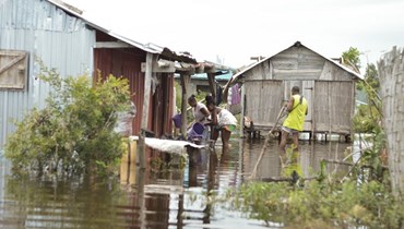سكان حي بيل سوفونير يحاولون استئناف حياتهم اليومية في منزلهم الغارق في المياه في سامبافا بعد مرور الإعصار تشينيسو (21 ك2 2023، أ ف ب). 